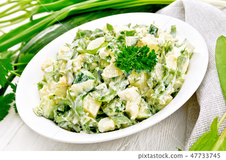 Salad with potatoes and sorrel on wooden board Salad with potatoes and sorrel on wooden board 47733745
