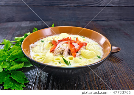 Soup creamy of chicken and pasta in plate on table 47733765