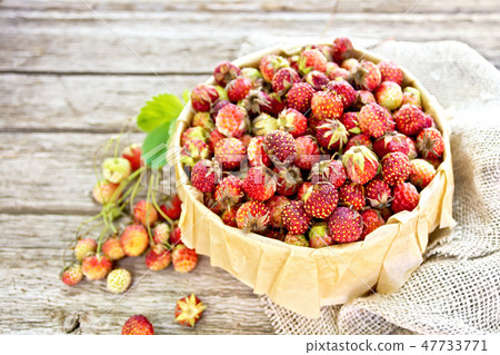 Strawberries in box on wooden board Strawberries in box on wooden board 47733771