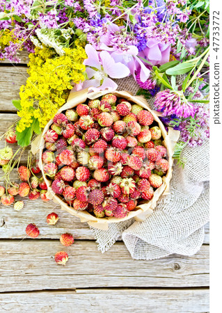 Strawberries in box with flowers on board top Strawberries in box with flowers on board top 47733772