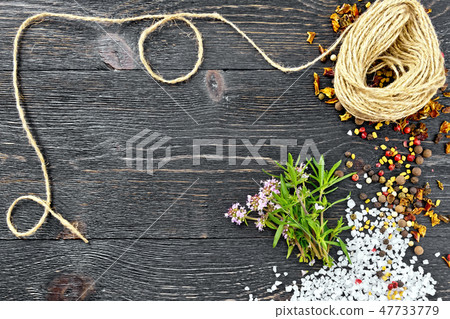 Thyme leaves and flowers with twine on black board 47733779