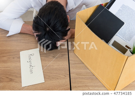 Businessmen are holding resignation document and packing persona Businessmen are holding resignation document and packing persona 47734185
