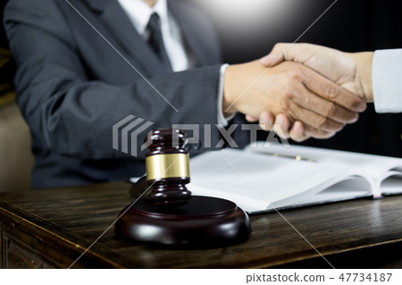 judge and client shaking hands in background at courtroom after judge and client shaking hands in background at courtroom after 47734187