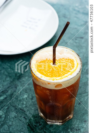 Iced coffee drink with orange slice 47736103