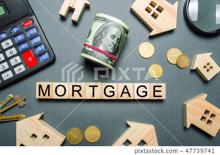 Wooden houses, a calculator, keys, coins  47739741