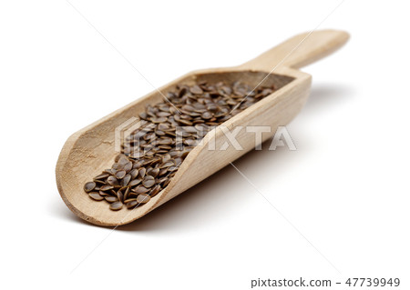 Nettle seeds in wooden spoon Nettle seeds in wooden spoon 47739949
