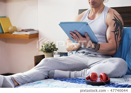 Man resting with tablet pc Man resting with tablet pc 47740044