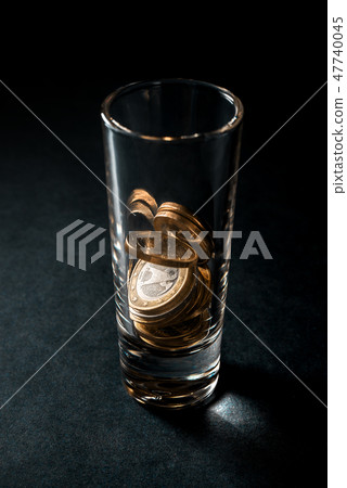 Glass for alcohol with Euro coins. Glass for alcohol with Euro coins. 47740045