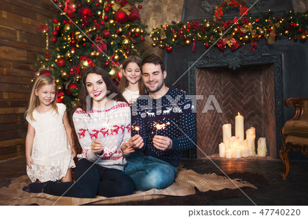 Happy family with sparklers celebrating Christmas 47740220
