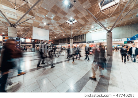 Motion blur of people walking in exhibition hall 47740295