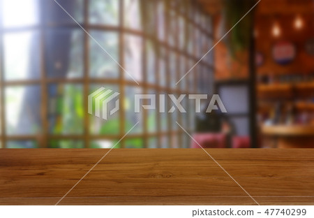 Empty wooden table in blur restaurant background Empty wooden table in blur restaurant background 47740299