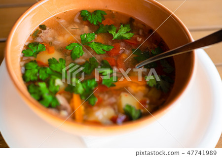 Clay plate with ear soup with a spoon Clay plate with ear soup with a spoon 47741989