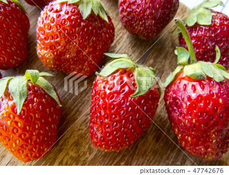 Strawberry on a wooden  background. 47742676