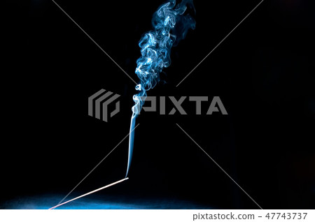 A mystic burning incense stick with scented smoke A mystic burning incense stick with scented smoke 47743737