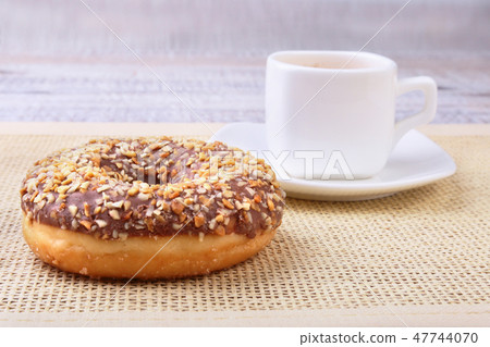 Coffee break with fresh donuts over textile background. Coffee break with fresh donuts over textile background. 47744070