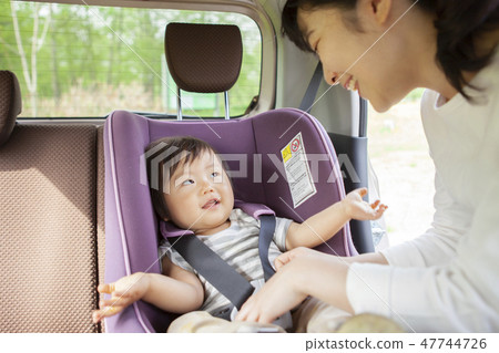 Baby sitting on a child seat 47744726