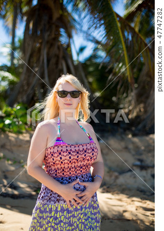 Young sexy blonde woman in dress near sea Young sexy blonde woman in dress near sea 47747282