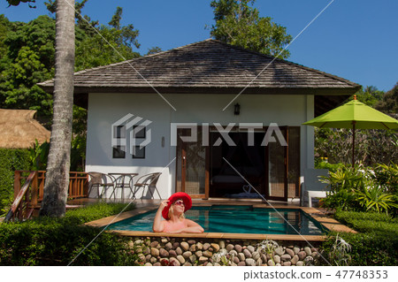 Young blonde beautiful woman in sunglasses in swimming pool Young blonde beautiful woman in sunglasses in swimming pool 47748353