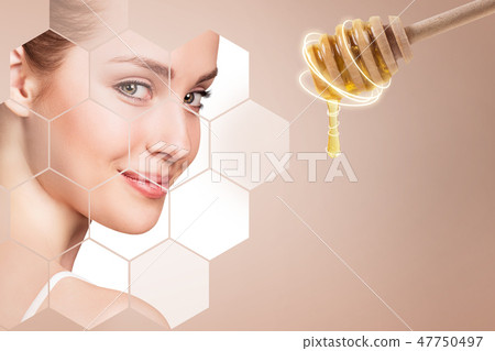 Young woman and honey spoon prepare for facial mask. 47750497