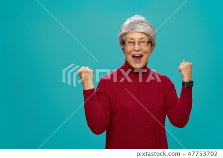 senior woman on teal background senior woman on teal background 47753702