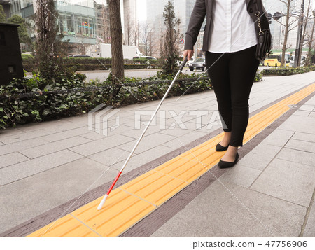 Visually impaired business woman walking braille block Visually impaired business woman walking braille block 47756906