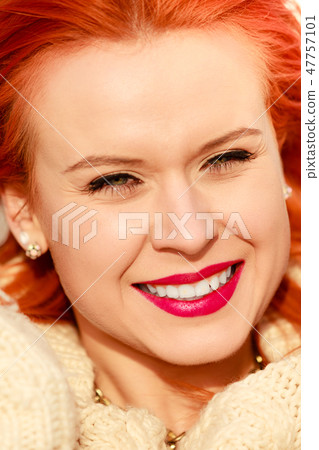 Beauty face red hair woman in warm clothing outdoor 47757101