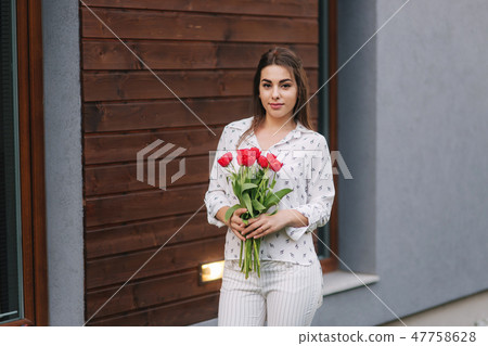 Happy woman hold a bouquet of flowers. 8th of march 47758628