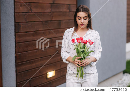 Happy woman hold a bouquet of flowers. 8th of march 47758630
