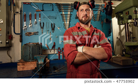 Closeup of auto mechanic on background with tools Closeup of auto mechanic on background with tools 47758902