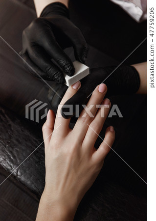 Manicure with black gloves, a polishing unit Manicure with black gloves, a polishing unit 47759206