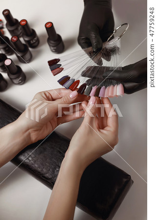 Master of manicure in black gloves 47759248