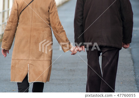 senior couple walking in the street senior couple walking in the street 47760055
