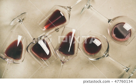 Flat-lay of red wine in glasses over grey Flat-lay of red wine in glasses over grey 47760134