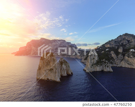 Faraglioni rocks towering up from bright blue Mediterranean waters on the island of Capri, Italy 47760250