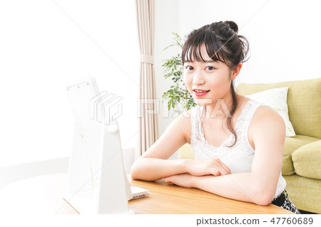 A young woman making skin care and makeup A young woman making skin care and makeup 47760689