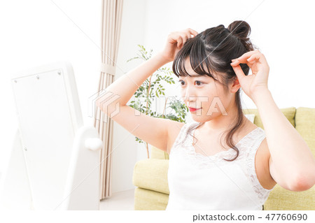 A young woman making skin care and makeup A young woman making skin care and makeup 47760690