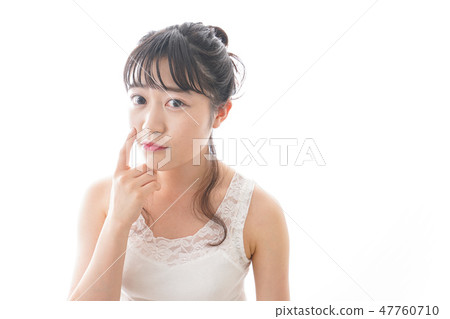 A young woman making skin care and makeup A young woman making skin care and makeup 47760710