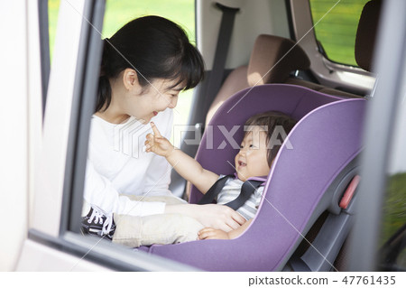 Baby sitting on a child seat 47761435