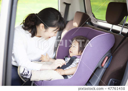 Baby sitting on a child seat 47761438