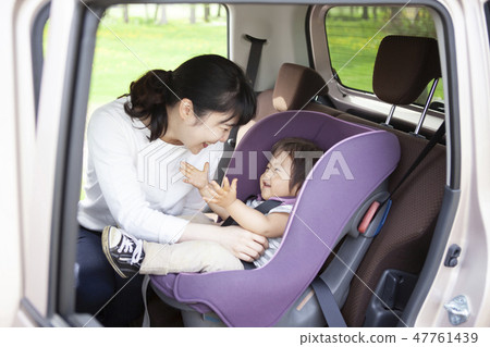 Baby sitting on a child seat 47761439