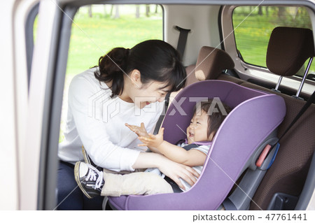 Baby sitting on a child seat 47761441