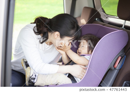 Baby sitting on a child seat 47761443