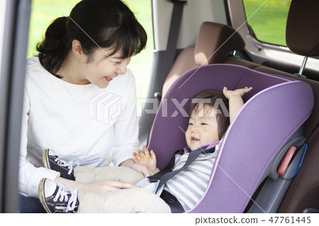 Baby sitting on a child seat 47761445