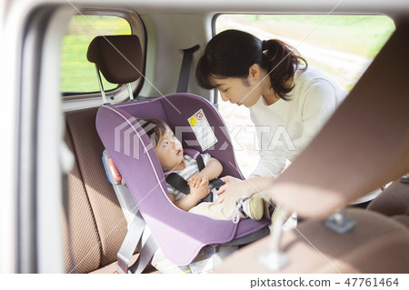 Baby sitting on a child seat 47761464