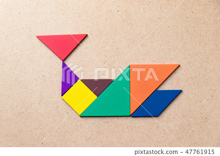Color tangram in whale shape on wood background 47761915