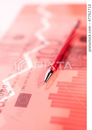 Finance background with money, stock market chart, graph and pen. Living coral toned. 47762718