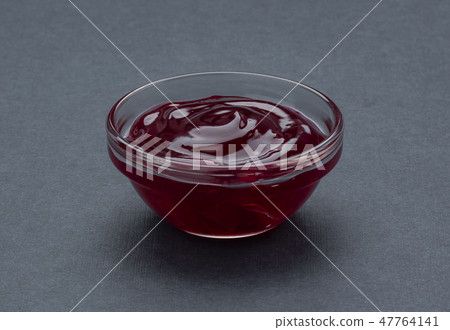 Bowl of berry jam isolated on black background 47764141