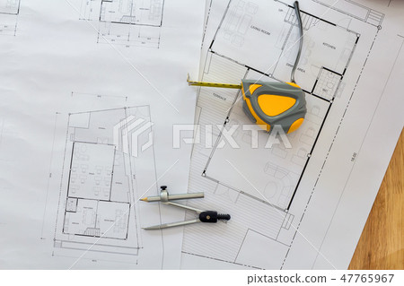 Measurement tool and dividers on blueprint 47765967