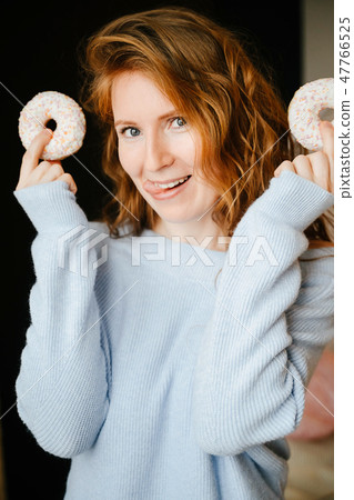 Portrait of a redhead girl and donuts. Portrait of a redhead girl and donuts. 47766525