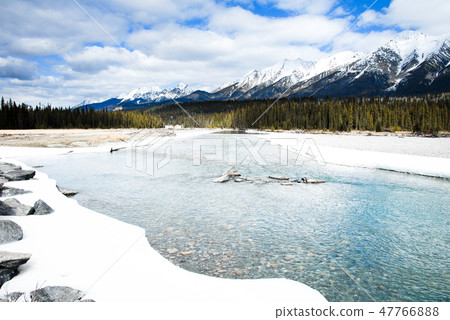 Winter Canadian · Rocky river and mountains of the Cooty National Park 47766888